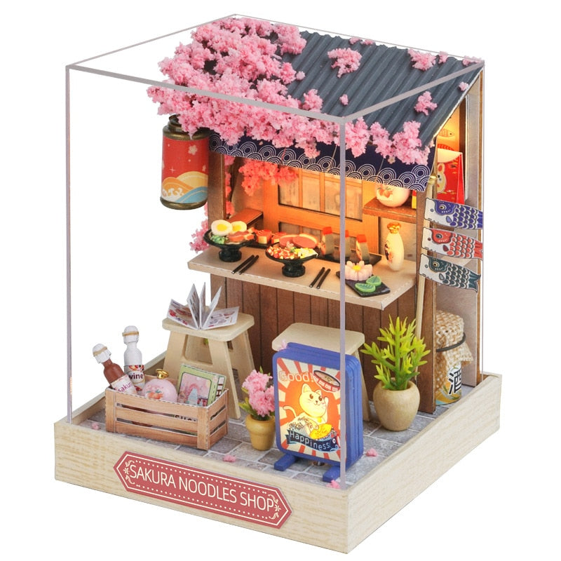 a model of a small shop with pink flowers