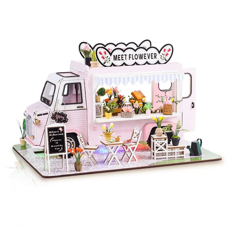 a model of a food truck with flowers on display
